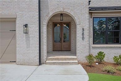 Doorway to property with french doors and brick si