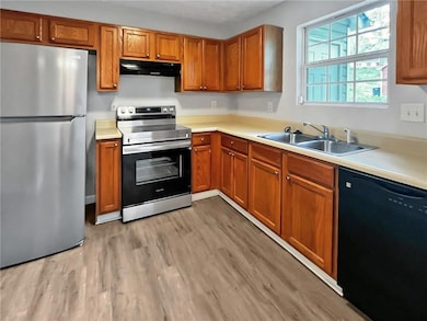 Kitchen with a sink, stainless steel appliances, u