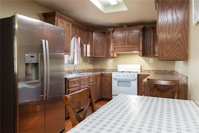 Modern Kitchen with Stainless Steel RefrigeratorThis kitchen features elegant cabinetry and a modern stainless steel refrigerator, blending functionality with style. Its thoughtful layout ensures everything is within reach, making meal prep a breeze. Think of how much easier cooking and hosting could be with a kitchen that works with you - not against you.