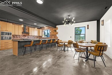 Dining area with concrete flooring and a chandelier