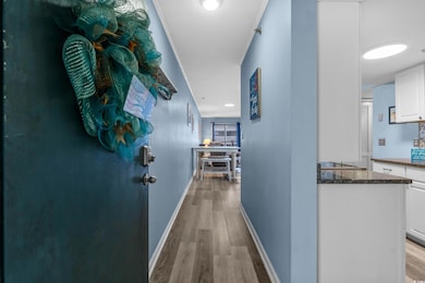 Corridor with baseboards and light wood-type flooring
