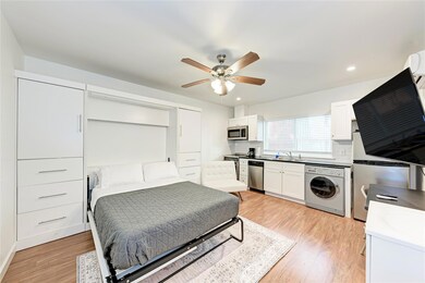 Bedroom with washer / dryer, light wood finished 