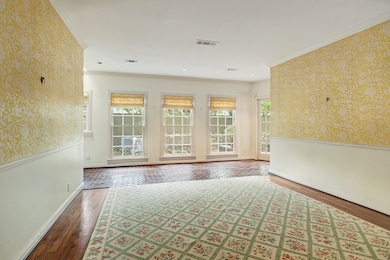 Dining room with pocket door to living room, kitchen access and open to back hall with views.