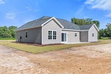Rear view of property featuring a patio and a lawn