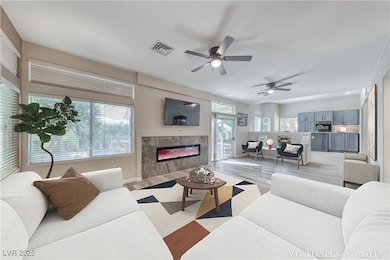 Living area with a tile fireplace, light wood-styl