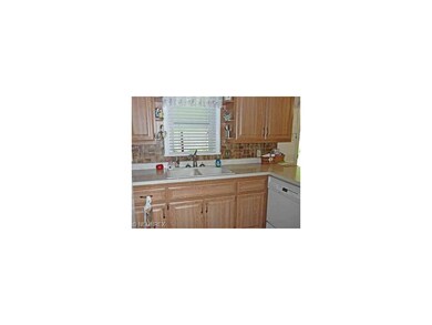 Updated dated kitchen with neutral decor.