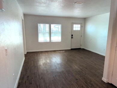 Entrance foyer featuring a textured ceiling, dark