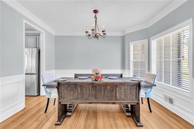 Dining room with light wood-style flooring, visibl