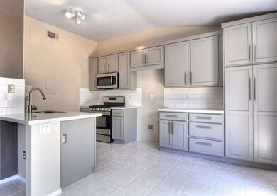 Sleek, remodeled kitchen boasts custom cabinets, s