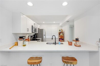 Kitchen with a kitchen breakfast bar, a sink, stai
