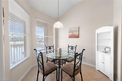 Dining area with vaulted ceiling, baseboards, and 