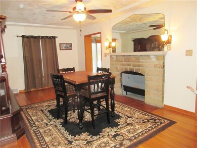 Dining room: Hardwood floors, wood burning stone f
