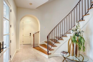 Inviting first floor entry with French doors, spir