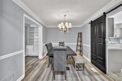 Dining space featuring crown molding, a textured c