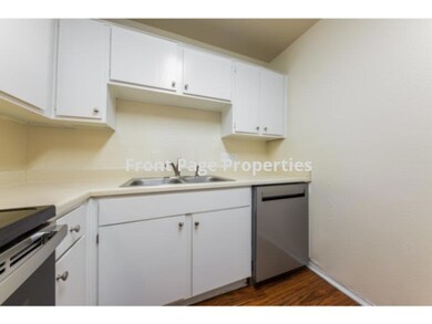Kitchen with stainless steel dishwasher, a sink, 
