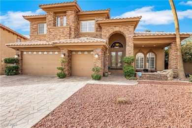 Mediterranean / spanish-style house featuring a ga
