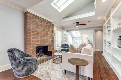 Living area featuring wood floors, baseboards, vau