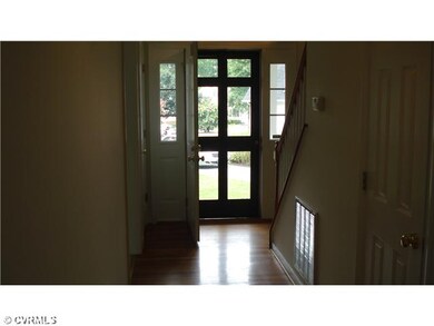 Foyer - Foyer with wood floors, guest bath