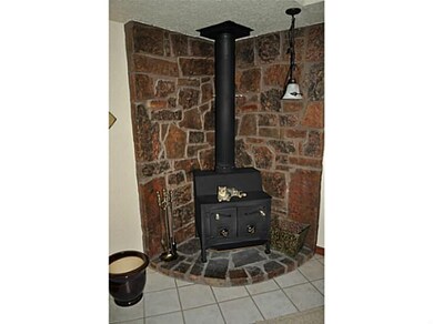 Den/Family/Great Room. Corner wood burning firepla