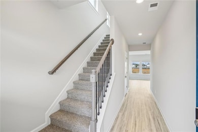 Staircase featuring wood-type flooring