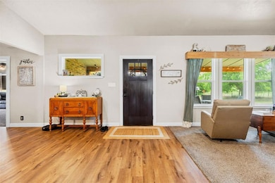 Entryway with wood finished floors and baseboards