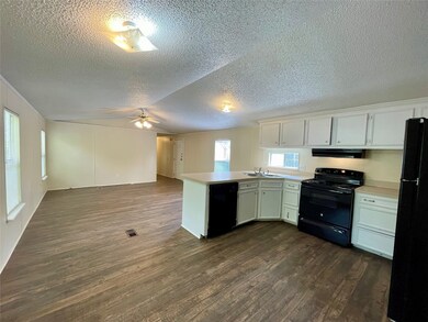 The kitchen overlooks the dining room for easy viewing and enjoying conversation with family and friends