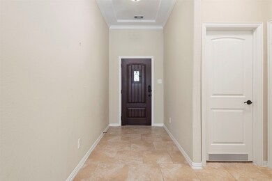 The entryway to the home opens to beautiful travertine flooring which flows throughout the living areas of the downstairs.