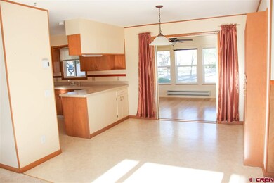 Open dining/kitchen/living + sunroom