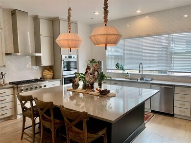 Kitchen featuring stainless steel appliances, wal