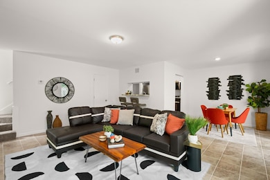 Living room featuring stairway and light tile pat