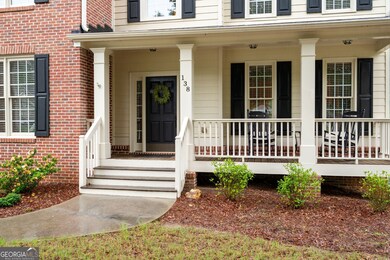 Cozy front porch with space for rocking chairs - perfect for relaxing.