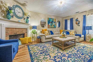 Living room with a fireplace, a textured ceiling, 