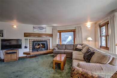 Up the stairs into the cozy living room with wood