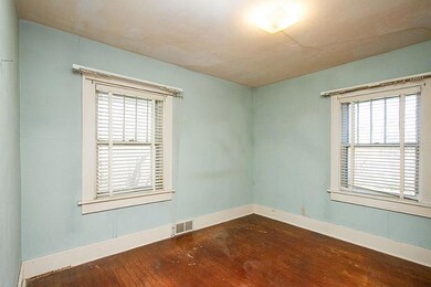 Bedroom with oak floors and wide woodwork