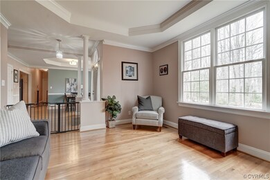 Living area featuring crown molding, light hardwoo