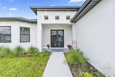 Property entrance featuring stucco siding and fren
