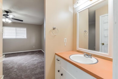 Bathroom featuring a ceiling fan and vanity