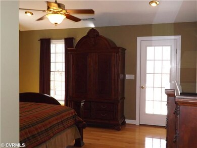 Master Bedroom - French door from the Master Bedroom...go into a cup of coffee or a glass of wine -while on the upper front porch...