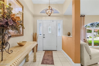 Entryway featuring tile patterned flooring and a chandelier