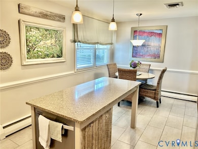 Dining area with a baseboard radiator and light tile patterned floors
