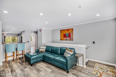 Living area featuring recessed lighting, ornamental molding, and wood finished floors