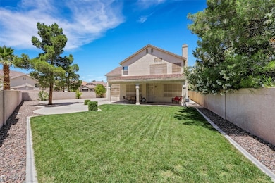 Backyard with covered patio area.