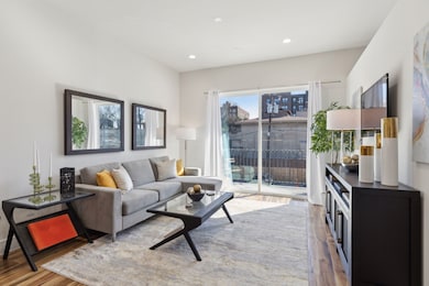 Living room with wood finished floors and recessed lighting