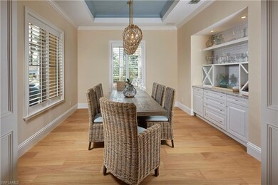 Dining room featuring crown molding, a tray ceilin
