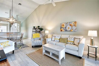 Living room with ceiling fan with notable chandeli
