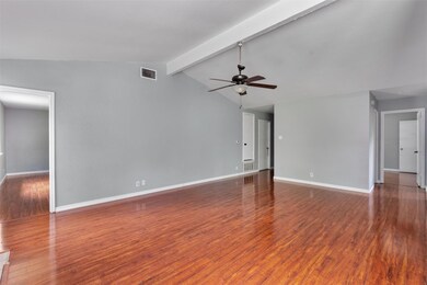 Unfurnished living room featuring ceiling fan and