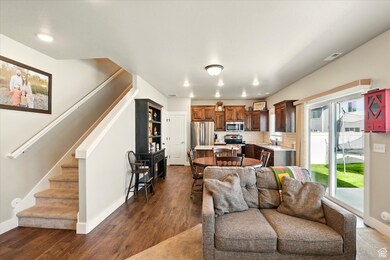 Living area featuring stairway, dark wood-style flooring, and recessed lighting
