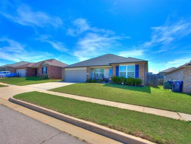 Ranch-style home featuring a garage and a front ya