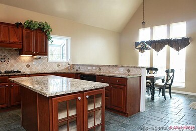 Kitchen with granite has breakfast nook.