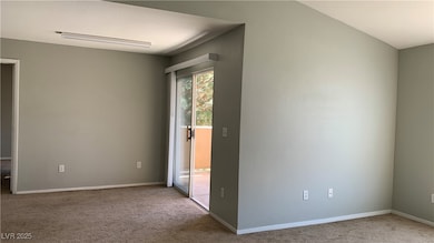 Spare room with carpet and baseboards